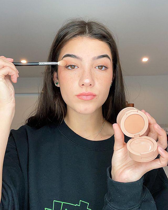 Charli damelio applying makeup around eyes